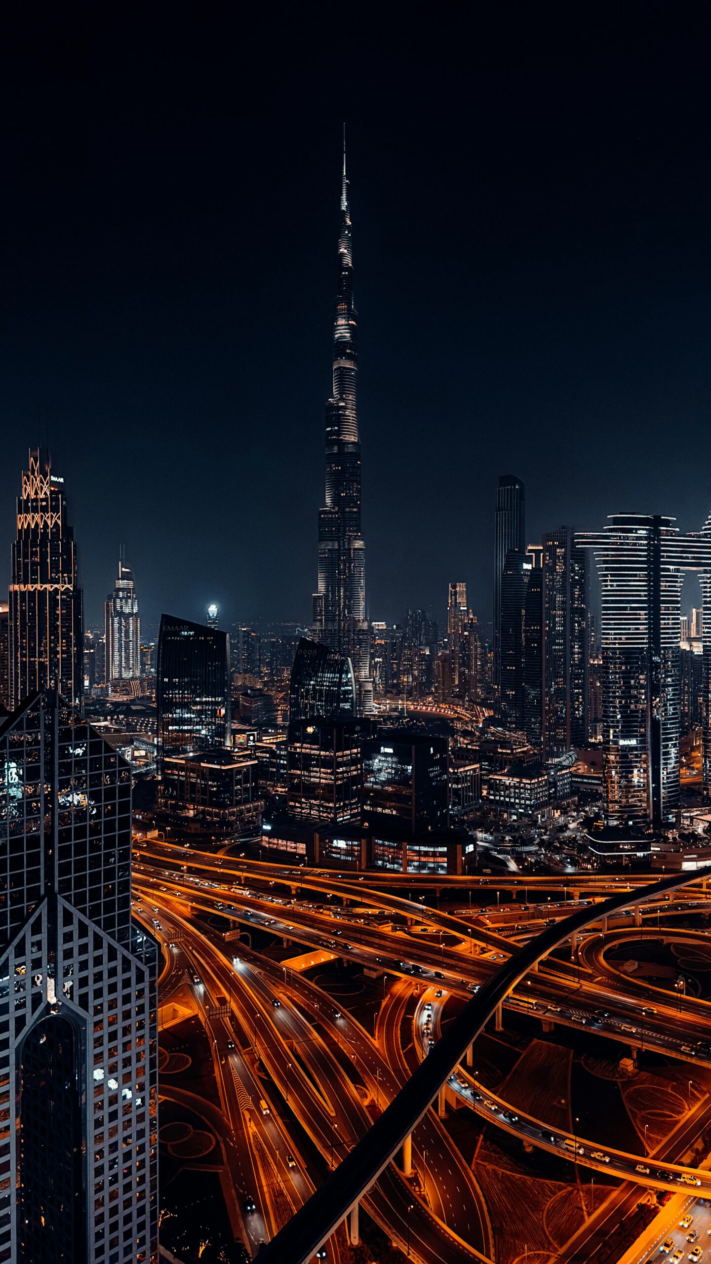 A breathtaking nighttime view of the illuminated Dubai skyline featuring the iconic Burj Khalifa.